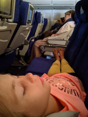 girl sleep in empty airplane seats