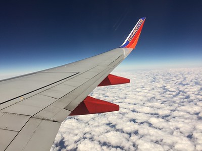 airplane wing on clouds